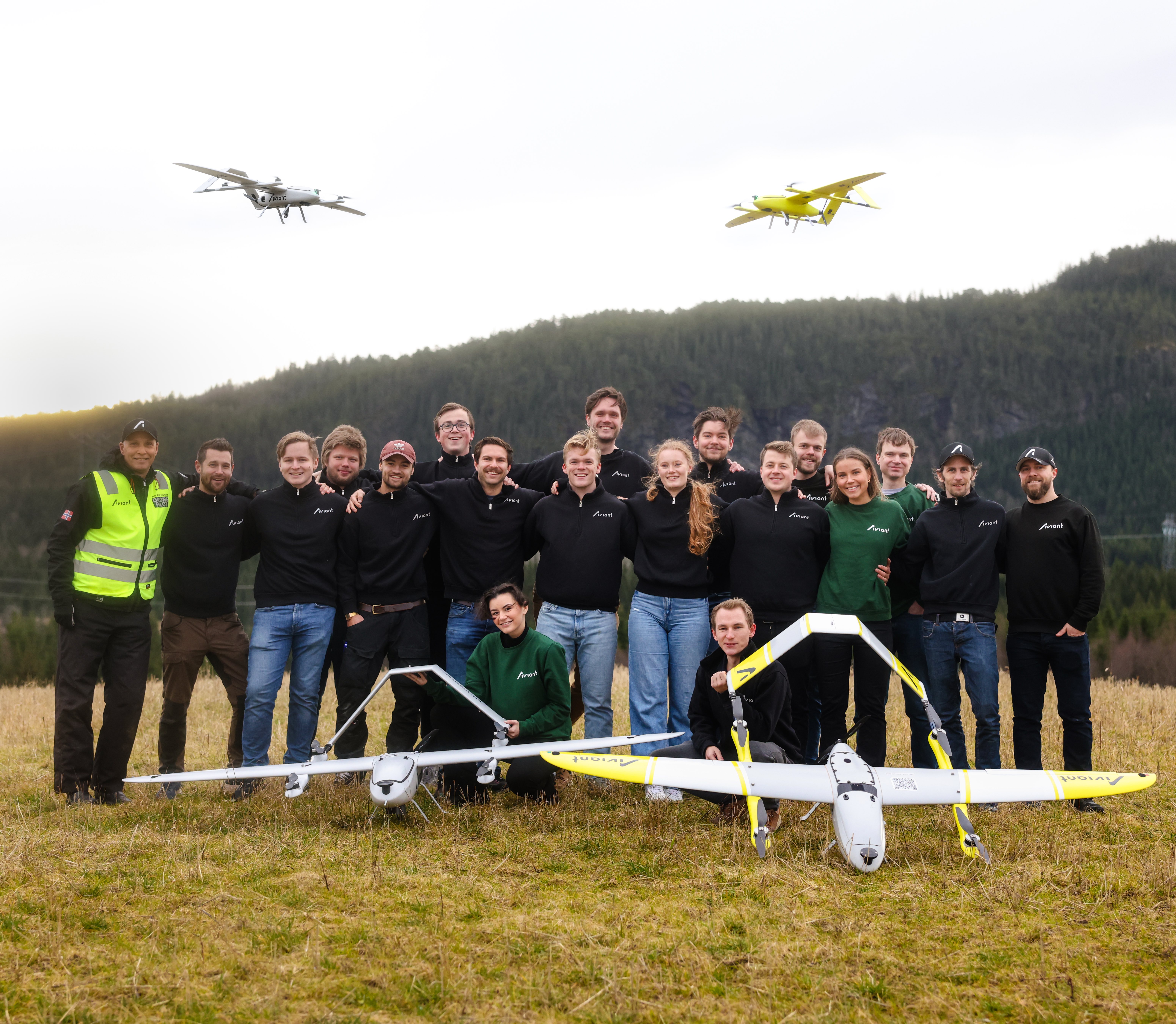 An image of the whole Aviant team posing with two drones